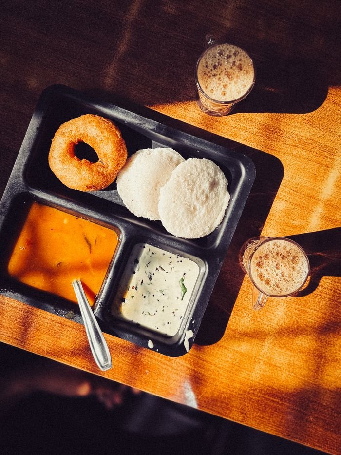 Crafting Captivating Headlines: Your awesome post title goes here Traditional South Indian breakfast featuring idli, vada, sambar, and chutney served with coffee.