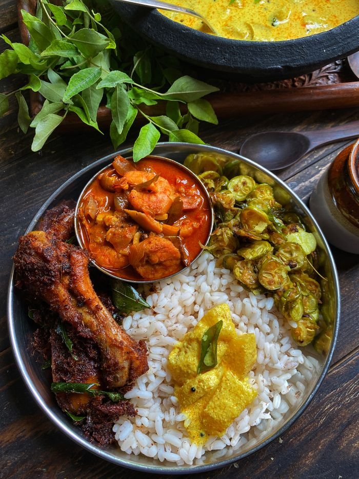 Home Delicious South Indian meal served with rice, curry, and vegetables, showcasing vibrant and flavorful cuisine.